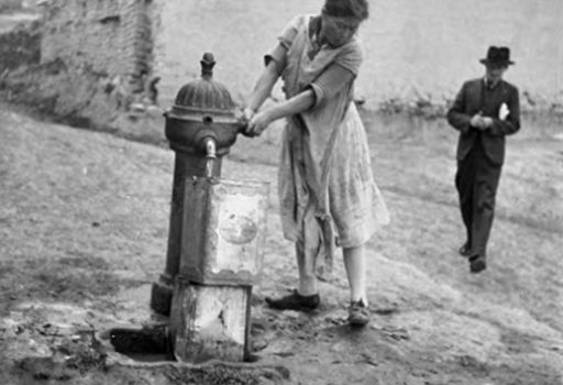 Woman public water pump Bogota