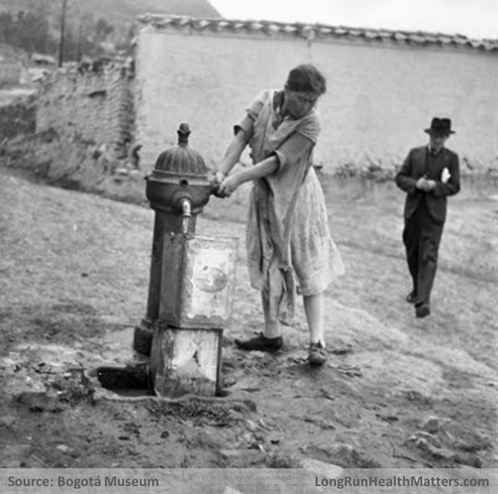 Woman public water pump Bogota